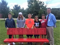 Cherrington Principal Andy Heck admires the school’s new bench with fifth grade students