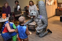 Steve Mazzi wearing a giant squirrel outfit and handing out treats to preschoolers at the annual Early Learning Center Pumpkin Walk.