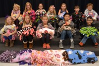 McVay Elementary students pose with some of the blankets they made to be distributed at the Ronald McDonald House.