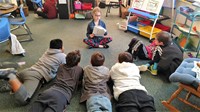 Walnut Springs student reads to a third grade class