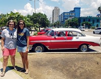 Spanish teachers pose in front of a vintage 1957 Chevy, parked in Havana. 