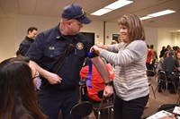 Brady Johnson, Captain of the Genoa Township Fire Department, offers advice to Central teacher Deanna Cavicchia on applying a tourniquet. 