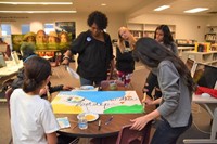 Mentor Davia Stevenson works with her group to create a board of inspiration for the Heritage Middle School community.