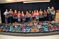 250 book bags filled with school supplies and personal hygiene products.