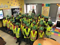 Kindergarten students with hard hats, goggles and vests