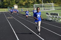 Robert Frost Elementary School students from running and walking around the track