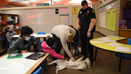 Chloe, a therapy dog-in-training for the Westerville Division of Police, greets students at Annehurst Elementary 