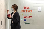 Madison “Lennon” Daniels paints a mushroom in the girls bathroom at Genoa Middle School.
