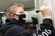 WNHS senior Chase Wood sketches drawings inspired by Halloween-themed jokes for AEC community