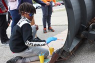 Painting the blades of snow plows at Walnut Springs