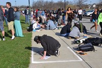 Student creating chalk murals