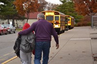 A Westerville City Schools bus driver helps a special needs student transfer to a different bus.