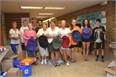 Caring & Sharing Volunteers Pack Hundreds of Book Bags with Donated Supplies