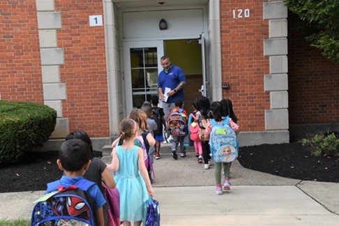 Kindergarten students entering school building