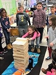 Studentsplaying a game of Giant Jenga. 