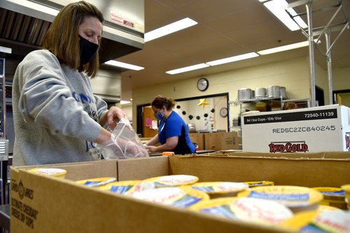 Food Services staff at Genoa Middle School package food for students' bagged meals.